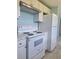 White stove, oven, and cabinets with a marble countertop at 317 E Green St, Englewood, FL 34223