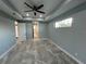 Spacious bedroom with high ceilings, ceiling fan, and tiled floors at 13342 Commonwealth Ave, Port Charlotte, FL 33981
