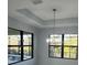 Bright dining area with chandelier and large windows overlooking the pool at 13342 Commonwealth Ave, Port Charlotte, FL 33981