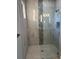 Spa-like shower with marble tile and glass enclosure at 13342 Commonwealth Ave, Port Charlotte, FL 33981