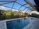 Enclosed pool with screened patio and water view at 13342 Commonwealth Ave, Port Charlotte, FL 33981