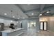 Open concept kitchen with island and breakfast bar, looking toward entryway at 13342 Commonwealth Ave, Port Charlotte, FL 33981