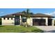 Single-Gathering home with two car garage and palm tree at 13342 Commonwealth Ave, Port Charlotte, FL 33981