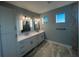 Elegant bathroom with double vanity, large mirror, and modern fixtures at 13342 Commonwealth Ave, Port Charlotte, FL 33981