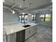 Large kitchen island with white cabinets and quartz countertop at 13342 Commonwealth Ave, Port Charlotte, FL 33981