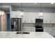 Modern kitchen with white cabinets, quartz countertops, and stainless steel appliances at 13342 Commonwealth Ave, Port Charlotte, FL 33981