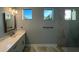 Modern bathroom with quartz vanity, frameless shower, and stylish fixtures at 13342 Commonwealth Ave, Port Charlotte, FL 33981