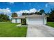 Single-story house with attached garage and landscaping at 122 Swan Dr, Rotonda West, FL 33947