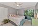 Bedroom with a queen bed, access to a private patio, and a ceiling fan at 5 Quails Run Blvd # 6, Englewood, FL 34223