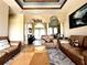 Relaxing living room with leather sofas, a large coffee table and high ceilings at 324 Santurce Ave, North Port, FL 34287