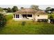 Back of house, featuring a covered patio and fenced backyard at 324 Santurce Ave, North Port, FL 34287