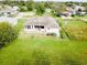 Back of house with covered patio, large backyard, and fenced area at 324 Santurce Ave, North Port, FL 34287