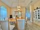 Elegant dining room featuring a chandelier and built-in hutch at 324 Santurce Ave, North Port, FL 34287