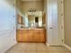 Elegant bathroom with double vanity and wood cabinets at 324 Santurce Ave, North Port, FL 34287