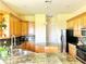 Well-equipped kitchen with wood cabinets, granite countertops, and stainless steel appliances at 324 Santurce Ave, North Port, FL 34287
