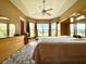 Main bedroom with large windows, ceiling fan, and ensuite bathroom at 324 Santurce Ave, North Port, FL 34287