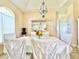 Formal dining room with glass-front cabinet and chandelier at 324 Santurce Ave, North Port, FL 34287