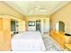 Main bedroom with large windows, ceiling fan, and ensuite bathroom at 324 Santurce Ave, North Port, FL 34287