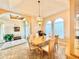 Elegant dining room with a large table, chandelier, and access to the kitchen at 324 Santurce Ave, North Port, FL 34287