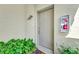 Inviting entryway with a neutral-toned door and potted plants at 3363 Grand Vista Ct # 203, Port Charlotte, FL 33953