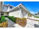 Front view of townhome showcasing a walkway and lush landscaping at 3363 Grand Vista Ct # 203, Port Charlotte, FL 33953