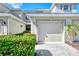 Townhome exterior featuring a garage and well-maintained landscaping at 3363 Grand Vista Ct # 203, Port Charlotte, FL 33953