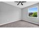 Bright bedroom with ceiling fan, gray walls, and a window view at 161 Mariner Ln, Rotonda West, FL 33947