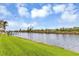 Scenic waterfront property with lush green landscaping and private dock at 15424 Lakeland Cir, Port Charlotte, FL 33981