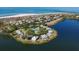Aerial view of Seawatch Lakeside community, showing homes, tennis courts, and a pool at 22 Seawatch Dr, Boca Grande, FL 33921