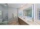 Elegant bathroom with dual sinks, a large mirror, and a glass shower at 22 Seawatch Dr, Boca Grande, FL 33921