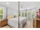 Spacious bedroom with a large bed, dresser, and window with shutters at 22 Seawatch Dr, Boca Grande, FL 33921