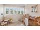 Charming bedroom with a crib, rocking chair and plenty of natural light at 22 Seawatch Dr, Boca Grande, FL 33921