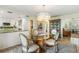 Bright dining area with glass table and seating for four, adjacent to kitchen at 22 Seawatch Dr, Boca Grande, FL 33921