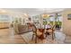 Elegant dining area with a glass-top table and modern chandelier at 22 Seawatch Dr, Boca Grande, FL 33921