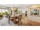 Bright dining room with a unique wood table and access to the kitchen at 22 Seawatch Dr, Boca Grande, FL 33921