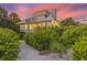 Two-story home with a metal roof, and lush landscaping at 22 Seawatch Dr, Boca Grande, FL 33921