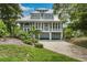 Two story home with metal roof and a large garage at 22 Seawatch Dr, Boca Grande, FL 33921