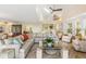 Open and airy living room with sectional sofa, hardwood floors and high ceilings at 22 Seawatch Dr, Boca Grande, FL 33921
