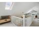 Open loft area with skylights and white railings overlooking the lower level at 22 Seawatch Dr, Boca Grande, FL 33921