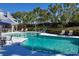 Inviting community pool with lounge chairs and a shaded area at 22 Seawatch Dr, Boca Grande, FL 33921