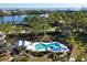 Community pool with lounge chairs and shaded areas at 22 Seawatch Dr, Boca Grande, FL 33921