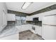 Kitchen boasts white cabinets, granite counters and tile backsplash at 3923 Cape Haze Dr # 306, Rotonda West, FL 33947