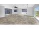 Spacious living room with tile floors, ceiling fan, and sliding glass doors to balcony at 3923 Cape Haze Dr # 306, Rotonda West, FL 33947