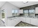 White kitchen with granite countertops and tile backsplash, plus sliding door access to outside at 3923 Cape Haze Dr # 306, Rotonda West, FL 33947