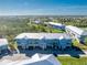 Aerial view of a community of light blue buildings with white roofs, garages, and landscaping at 3923 Cape Haze Dr # 306, Rotonda West, FL 33947