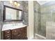 Elegant bathroom with glass shower, marble vanity, and stone tile at 3923 Cape Haze Dr # 306, Rotonda West, FL 33947