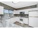 Updated kitchen with white cabinets, granite countertops and tile flooring at 3923 Cape Haze Dr # 306, Rotonda West, FL 33947