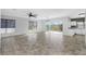 Spacious living room with tile floors, ceiling fan, and sliding glass doors to balcony at 3923 Cape Haze Dr # 306, Rotonda West, FL 33947