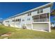 Building exterior with balconies and lawn at 3923 Cape Haze Dr # 306, Rotonda West, FL 33947