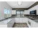 Modern kitchen with white cabinets, granite countertops, and tile flooring at 3923 Cape Haze Dr # 306, Rotonda West, FL 33947